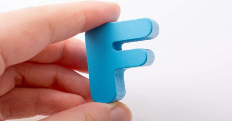 Hand Holding the Letter F
